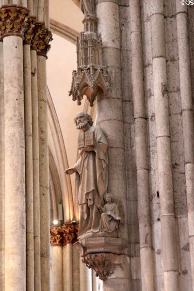 Statue of Evangelist St Matthew with his angel symbol at Köln Cathedral. Köln, Germany.