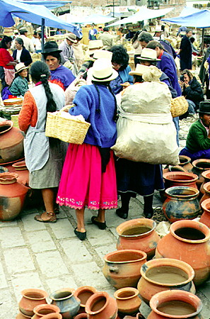 Women in traditional dress in the market of Cuenca. Ecuador.