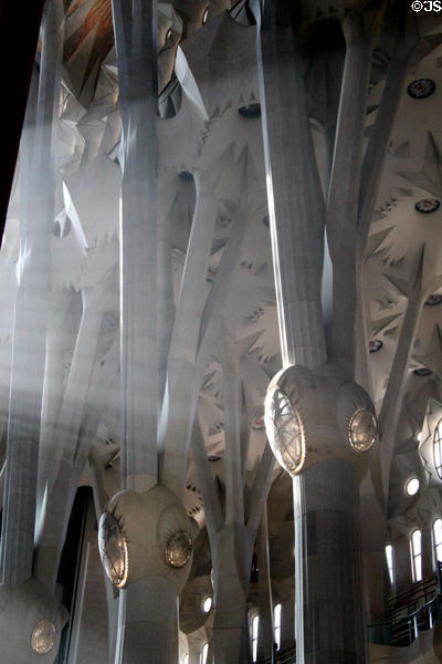 Sunshine streams through columns in Sagrada Familia. Barcelona, Spain.