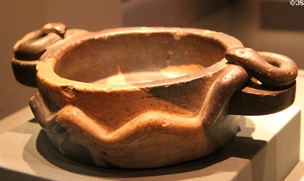 Stone mortar in circled by snakes (1450-1533) from Inca Culture, Peru at Barbier Mueller Precolumbian Art Museum. Barcelona, Spain.