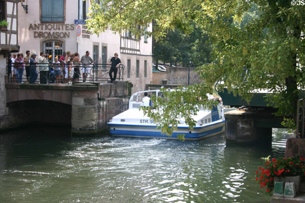 Boat navigates locks of Petite France area of L'Ill River. Strasbourg, France.