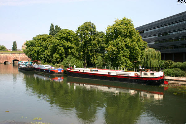 Barges on L'Ill River beside Vauban Dam & Hotel du Departement. Strasbourg, France.