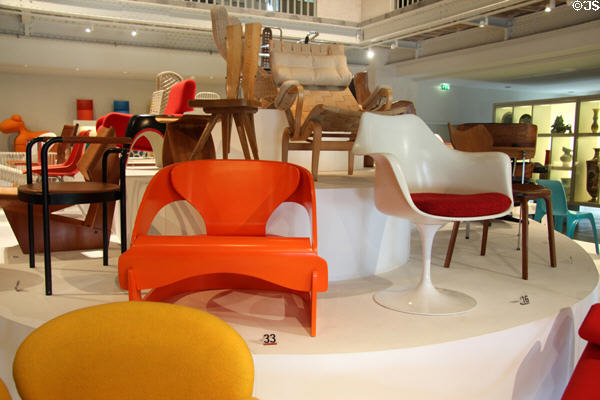 Armchairs orange (1964) by Joe Colombo of Italy & white Tulip (1955-6) by Eero Saarinen from Finland at Museum of Decorative Arts. Paris, France.