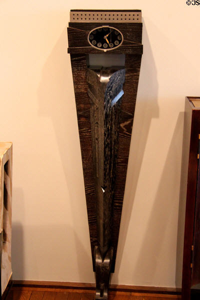 Modern wall clock atop oak column with luminous face (1925) by Pierre Legrain of Paris at Museum of Decorative Arts. Paris, France.
