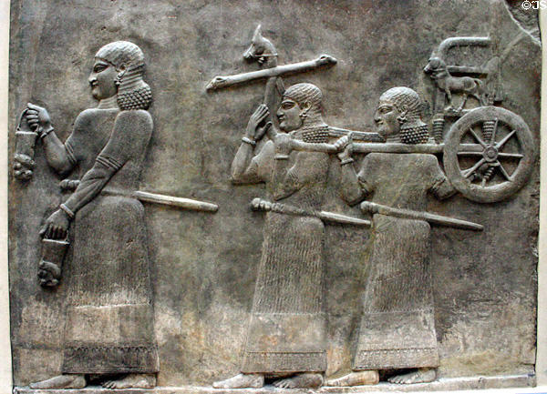 Babylonian relief of servants carrying small chariot (c710 BC) from citadel of Dur-Sharukkin at the Louvre Museum. Paris, France.