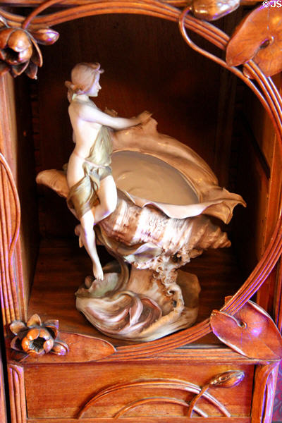 Statuette holding conch shell at Maxim's Art Nouveau Collection 1900. Paris, France.