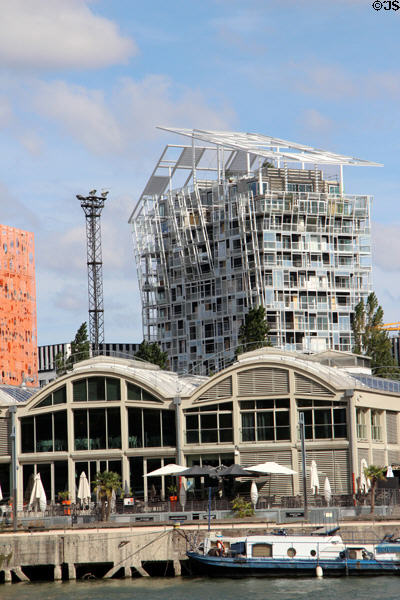 Ycone housing tower (2018) over Saône riverside restaurants. Lyon, France.