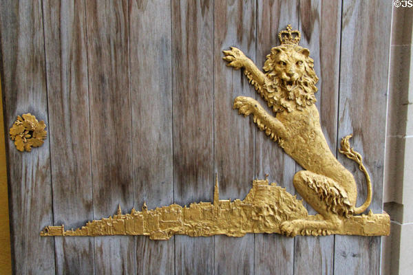 Royal lion over Royal Mile profile of Edinburgh on entrance doors at Queens Gallery. Edinburgh, Scotland.