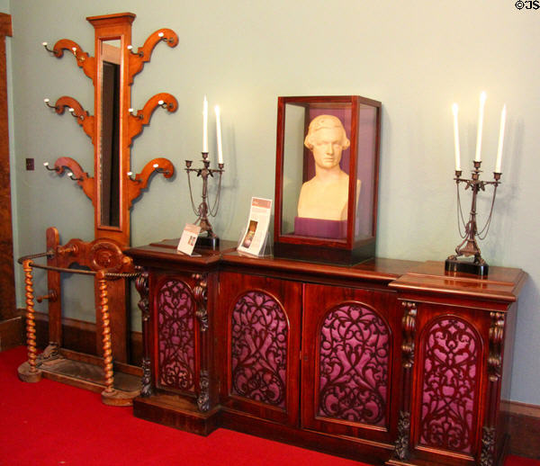 Hat & umbrella stand beside sideboard with candlesticks in parlor at Holmwood. Glasgow, Scotland.