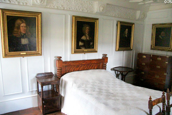 Tartan bedroom with family portraits at Craigievar Castle. Alford, Scotland.