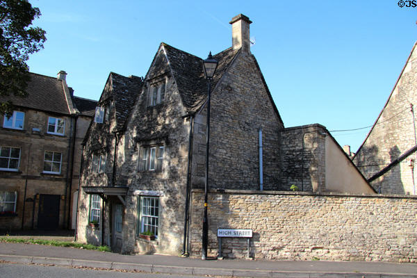 Vintage stone building with steep gables on High Street. Northleach, England.