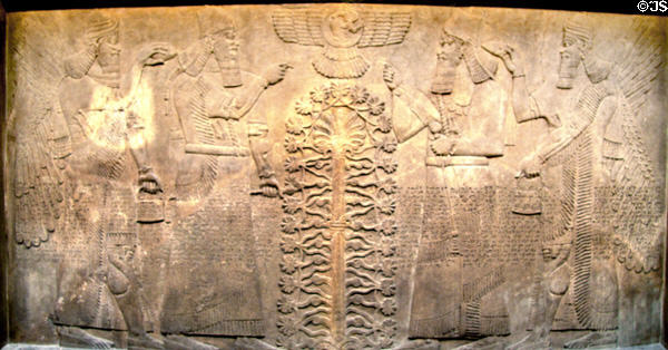 Assyrian carved panel portrays King Ashurnasirpal II under divine protection (c883-859 BCE) from North-West Palace of Nimrud at British Museum. London, United Kingdom.