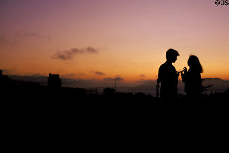 Couple toast sunset & Golden Gate Bridge. San Francisco, CA.