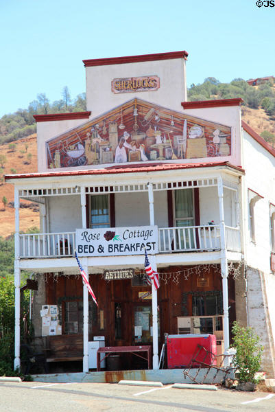 Sherlocks (aka Bruschi Bros.) warehouse with mural depicting early days in Coulterville. Coulterville, CA.