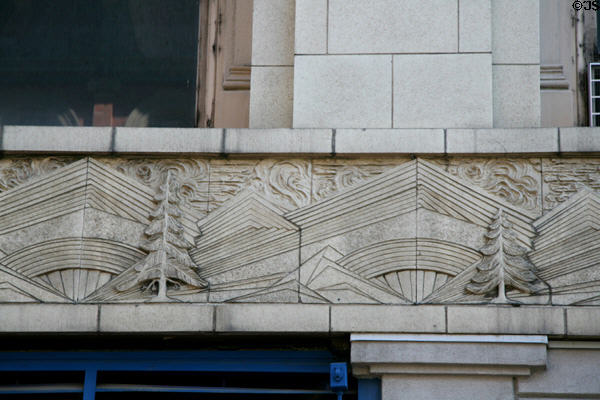 Art Deco terra cotta mix of trees, mountains & urban lines on Colorado Building. Denver, CO.