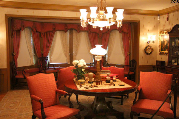 Drawing room table & chairs with lamps & collections at Hill-Stead Museum. Farmington, CT.