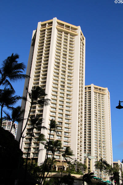 Octagonal twin Hyatt Regency Waikiki Towers over palms. Waikiki, HI.