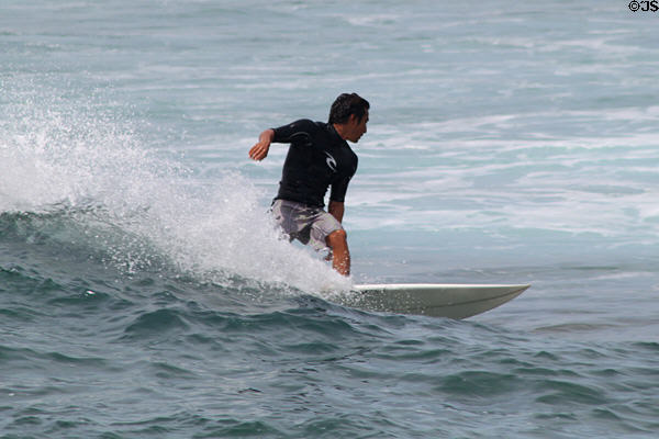 Standing surfers off Waikiki Beach. Waikiki, HI.