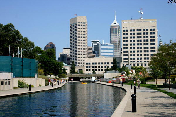 AUL (OneAmerica) Tower (1982) with flag above Central Canal. Indianapolis, IN. Style: Modern. Architect: Skidmore, Owings & Merrill.
