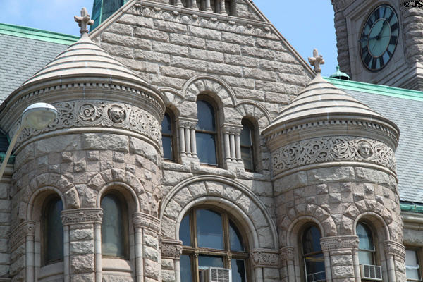 Projecting stone towers of Lowell City Hall. Lowell, MA.