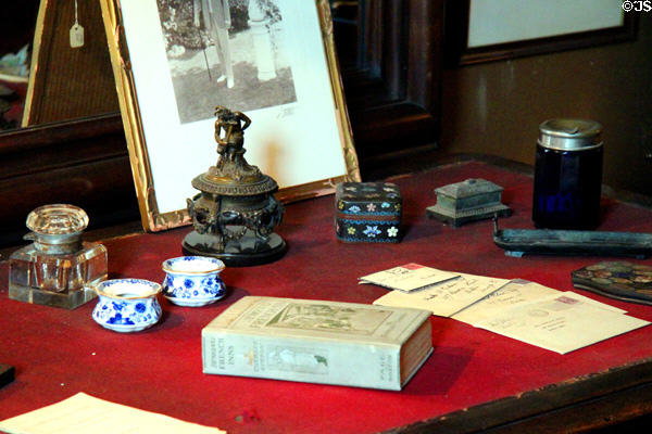 Desktop with mementos of Charles Gibson at Gibson House Museum. Boston, MA.