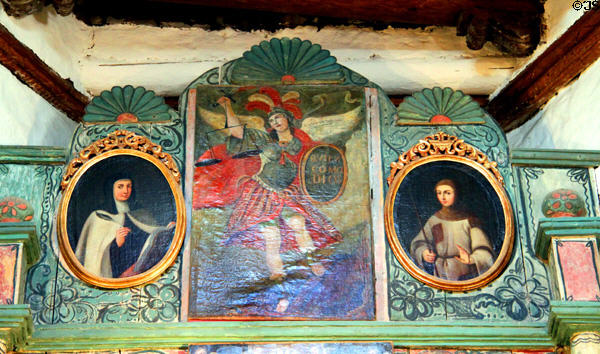 Painting of St Michael with St Teresa & St Gertrude atop reredos of San Miguel Mission. Santa Fe, NM.