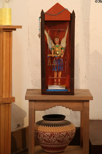 Spanish-style carving of St Michael over native pot at San Miguel Mission. Santa Fe, NM.