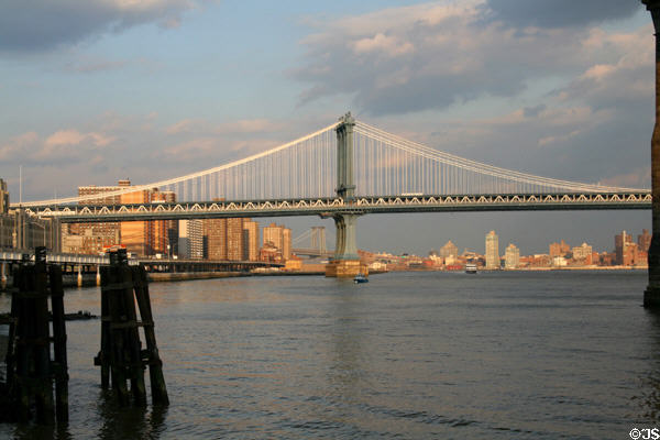 Manhattan & Brooklyn skylines under Manhattan Bridge. New York, NY.