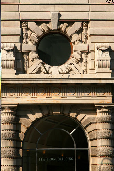Round window & columns surround door of Flatiron Building. New York, NY.