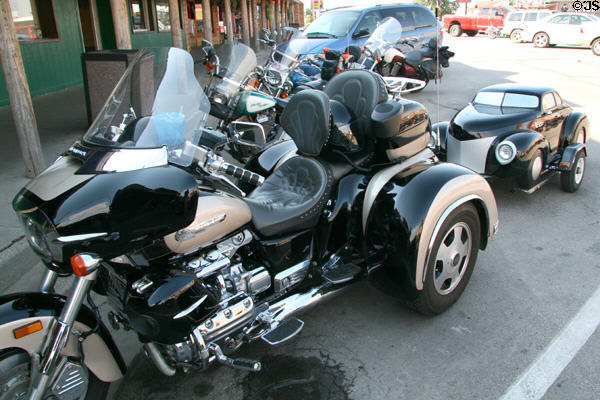 Motorcycle with trailer in shape of small car. Wall, SD.
