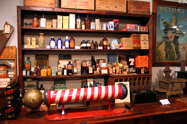 Barber pole & shelves of medicine & cosmetic bottles in General Store at Sam Houston Park. Houston, TX.