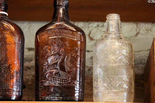 Post-1935 liquor bottles marked "Federal law prevents sale or reuse of this bottle" in Kammlah general store at Pioneer Museum. Fredericksburg, TX.