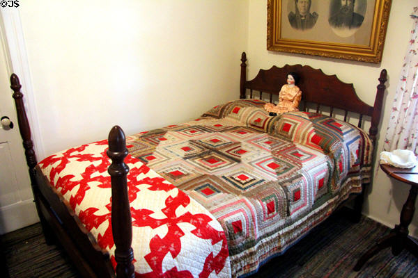 Walnut poster bed attrib. Johann Jahn with Civil War era quilt in "log cabin" pattern at Museum of Texas Handmade Furniture. New Braunfels, TX.