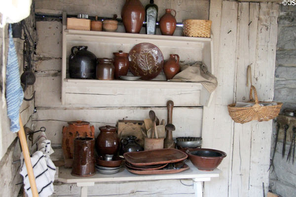 Redware pottery in Settlers' Cabin (c1800) at Shelburne Museum. Shelburne, VT.