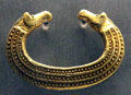 Ancient gold jewelry with two horses heads from Romania at Museum of Natural History. Vienna, Austria.