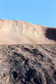 Tiny moon in a blue sky above Uluru. Australia.