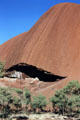 Overhanging mouth of a cave at base of Uluru. Australia
