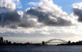 Sydney Harbour Bridge & opera house under cloud formation. Sydney, Australia.