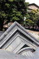 Sculpture of partial column & pediment sink into sidewalk at Melbourne library. Melbourne, Australia.
