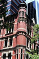 Round tower corner of a red brick building at Bourke & Church Streets in Melbourne. Melbourne, Australia.