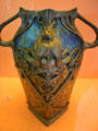 Iridescent glass vessel in pewter frame with female face Art Nouveau decoration by Loetz Manuf. of Klostermühle, Austria at Ariana Museum. Geneva, Switzerland.