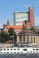 Red tower of Atlantic-Haus above Brown dome of Alter Elbtunnel at St Pauli Pier. Hamburg, Germany.