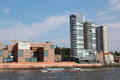 Tourist boat sailing past modern buildings in Altona borough. Hamburg, Germany.