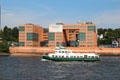 Tourist boat sailing past modern office building in Altona borough. Hamburg, Germany.