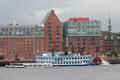Tourist boats sailing along Elbe River in front of Altona, western borough of Hamburg. Hamburg, Germany.