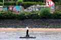 Buoy-men, floating statue of man on raft in Elbe River by Stephan Balkenhol at Altona borough. Hamburg, Germany.
