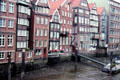 Typical Hanseactic brick buildings lining Hamburg canal at low tide. Hamburg, Germany.