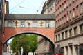 Arched bridge over Maffeistraße between two commercial buildings. Munich, Germany.