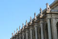 Row of Greek god statues on Munich Residenz over garden courtyard. Munich, Germany.