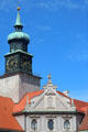 Clock tower with sundial over Baroque roofline in Brunnenhof courtyard at Munich Residenz. Munich, Germany.